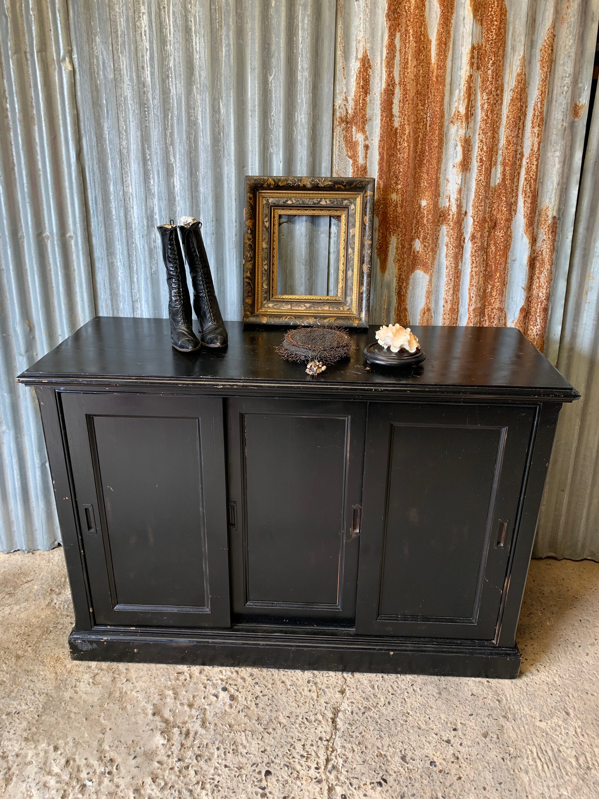 A black ebonised shop counter display cabinet