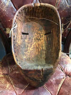 A carved wooden bird head mask from the Dan tribe