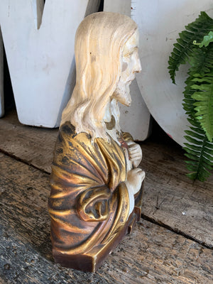 A plaster bust of Jesus with flaming Sacred Heart