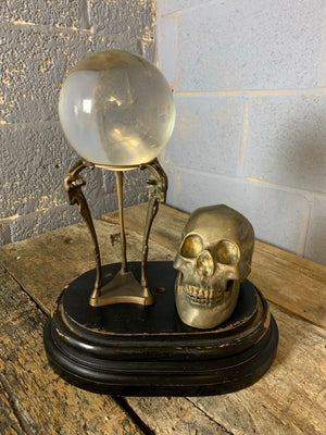 A large fortune teller's crystal ball with goat head stand