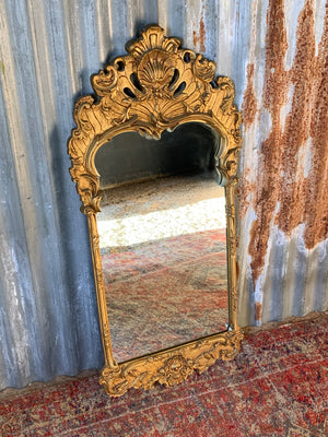 A large Rococo style cast iron mirror