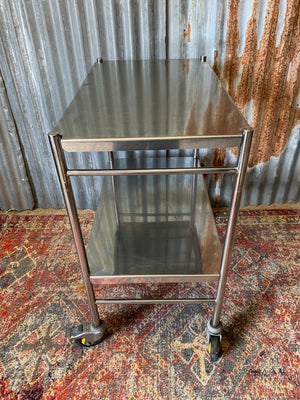 A stainless steel two-tier medical trolley ~ 1