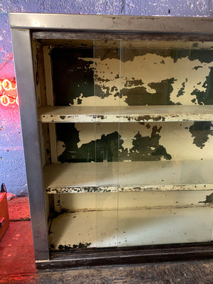 A vintage industrial stripped steel medical cabinet