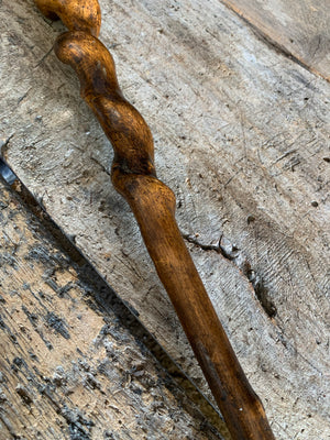 A wooden dog's head walking stick with glass eyes