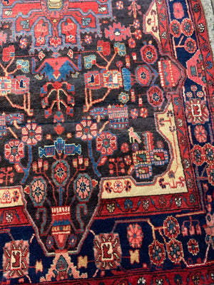 A very large rectangular red ground Persian rug