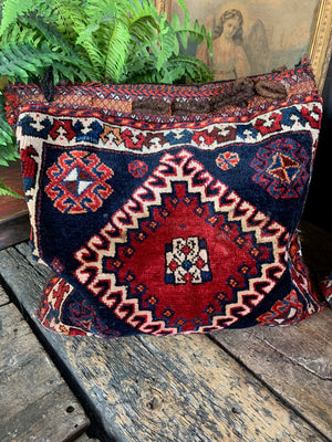 A pair of Persian carpet cushions