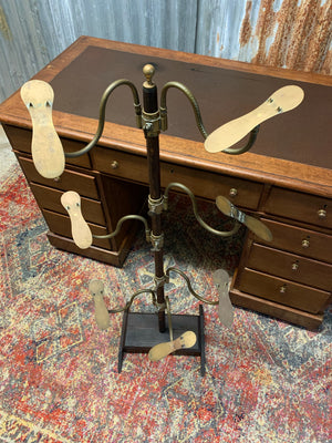 A wood and brass shoe shop display stand by Potter