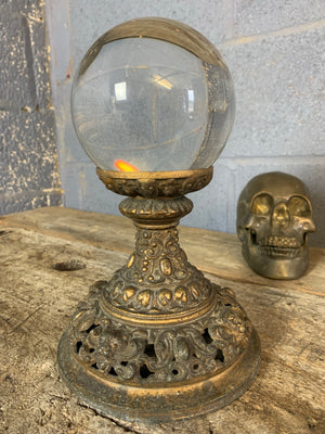 A fortune teller's crystal ball on a gilt leopard head stand