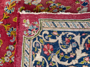 A fuchsia ground Persian rectangular rug
