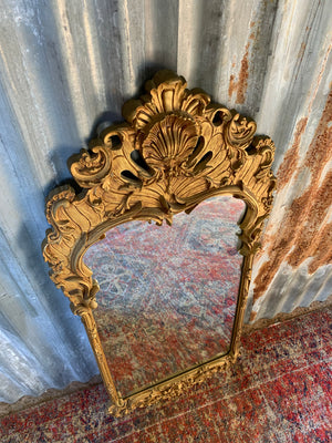 A large Rococo style cast iron mirror