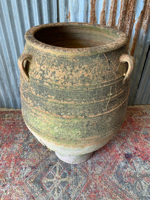 A very large terracotta olive jar