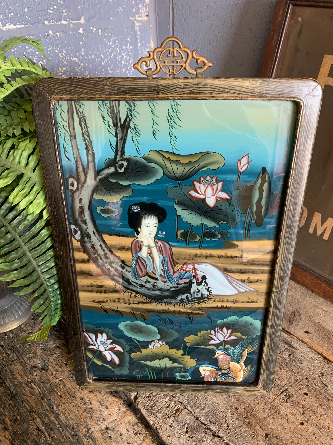 A large reverse painted glass Geisha picture