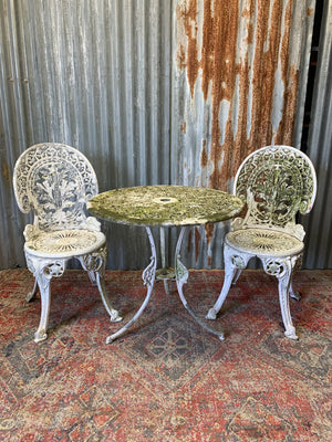 A white cast metal garden set - a table and two chairs