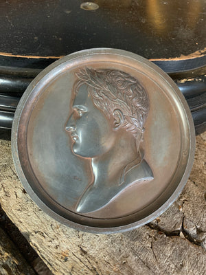 A framed "bronzed" lead medallion of Napoleon