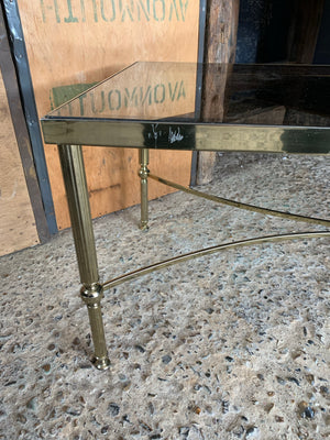 A Hollywood Regency rectangular coffee table with smoked glass