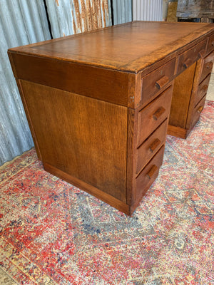 A Modernist oak twin pedestal desk