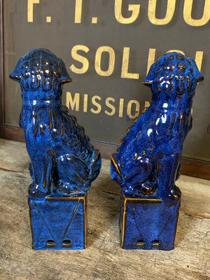 A pair of dark blue ceramic Chinese foo dogs