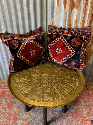 A pair of Persian carpet cushions
