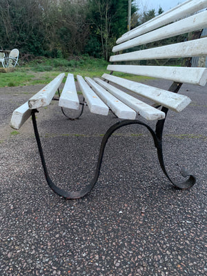 A wrought iron and wood garden bench