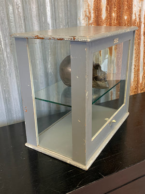 A wood and glass medical display cabinet