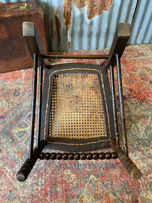 A 19th Century bobbin chair with cane seat by Bowen & Mallon