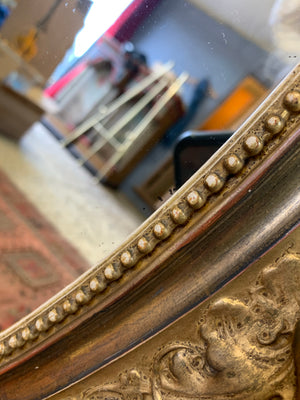 A large 19th century oval gilt mirror