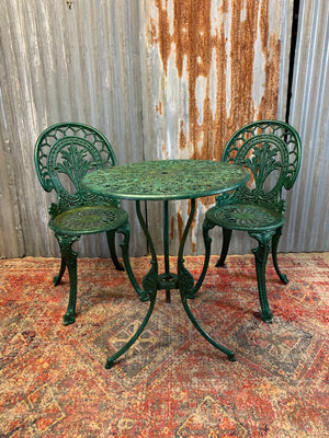 A green garden table and chairs set