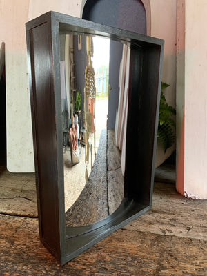 A wooden ebonised fairground distortion mirror