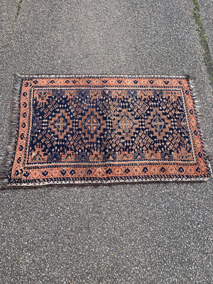 A orange blue ground Persian rectangular rug 129cm x 79cm
