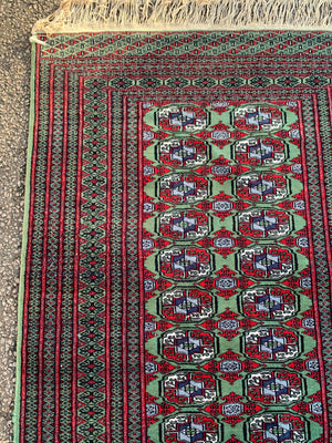 A Persian Bokhara rectangular rug - red/green tones