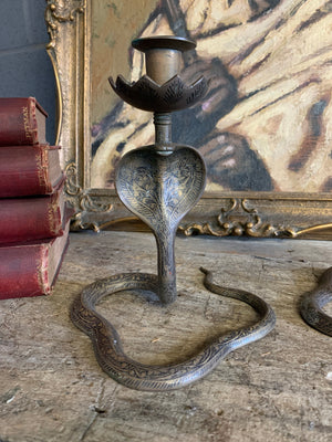 A pair of Indian or North African cobra candlesticks