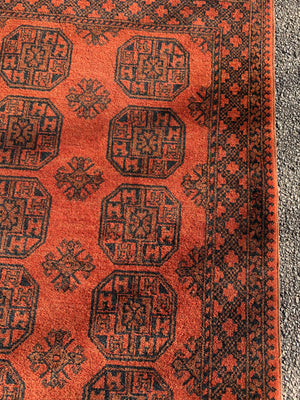 A burnt orange ground Bokhara rectangular rug- 195cm x 124cm