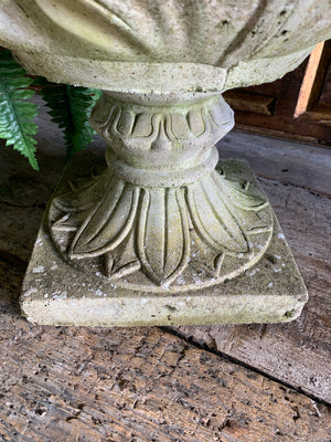 A pair of large tulip or acanthus pattern cast stone urns