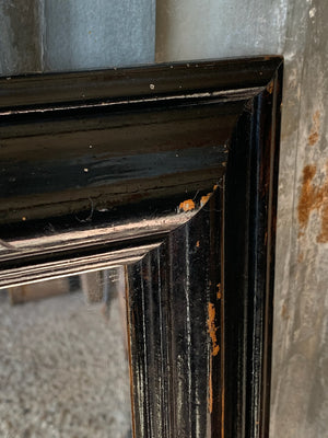 A large rectangular ebonised mirror