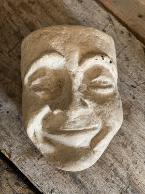 A white papier-mâché mask