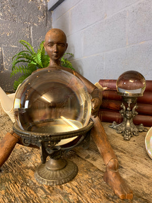 A fortune teller's crystal ball on a silver plated Art Nouveau stand