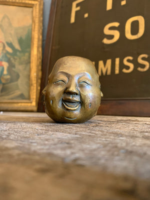 A trio of Asian bronze four faced Buddha heads