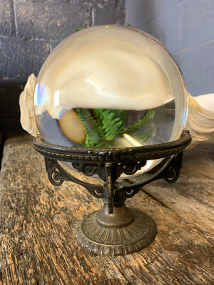 A fortune teller's crystal ball on a silver plated Art Nouveau stand