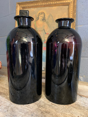 A pair of very large amethyst glass apothecary bottles