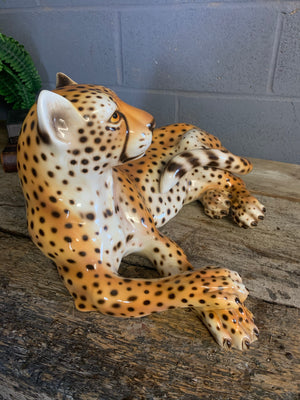 A ceramic mid-century cheetah and cubs statue set