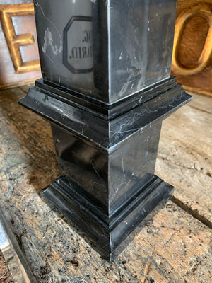 A large black marble obelisk