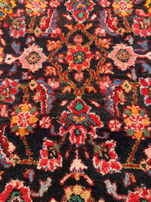 A large red ground Persian runner - 277cm x 116cm