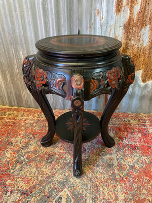 A Chinese ebonised carved stand
