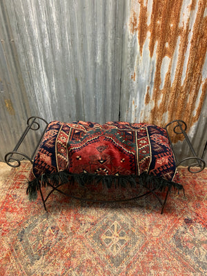 A large rectangular Persian carpet floor cushion