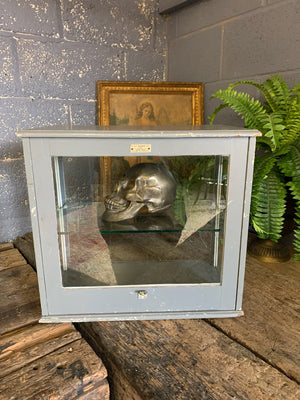 A wood and glass medical display cabinet