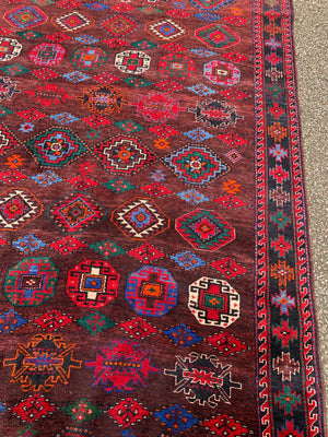 A large Persian red ground runner rug