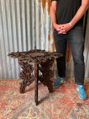 A profusely carved Anglo-Indian table by Jubbar Khan & Son