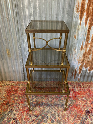 A brass and glass Hollywood Regency nest of tables