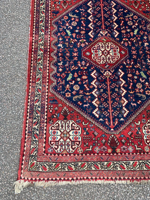 A red ground animal motif Persian rectangular rug 156cm x 105cm
