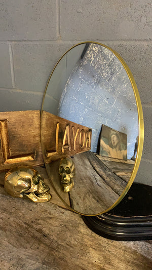 A large gold convex mirror